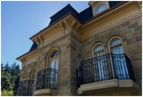 After: closeup of front façade with reconstructed Juliet balconies. Central balcony is former front entrance.